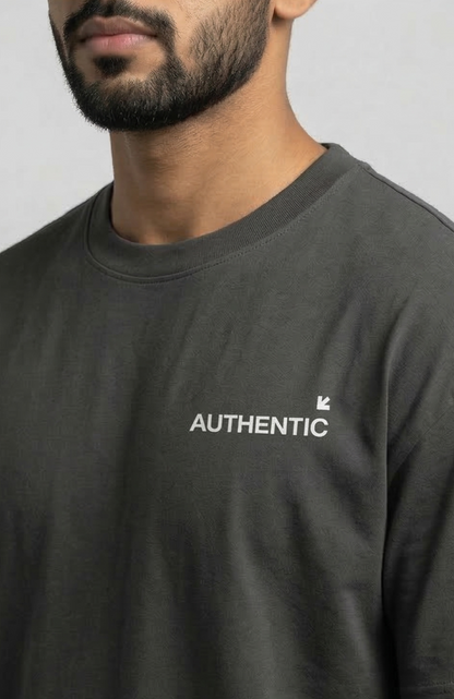 Person wearing a black t-shirt with 'AUTHENTIC' logo on Left side of the chest.