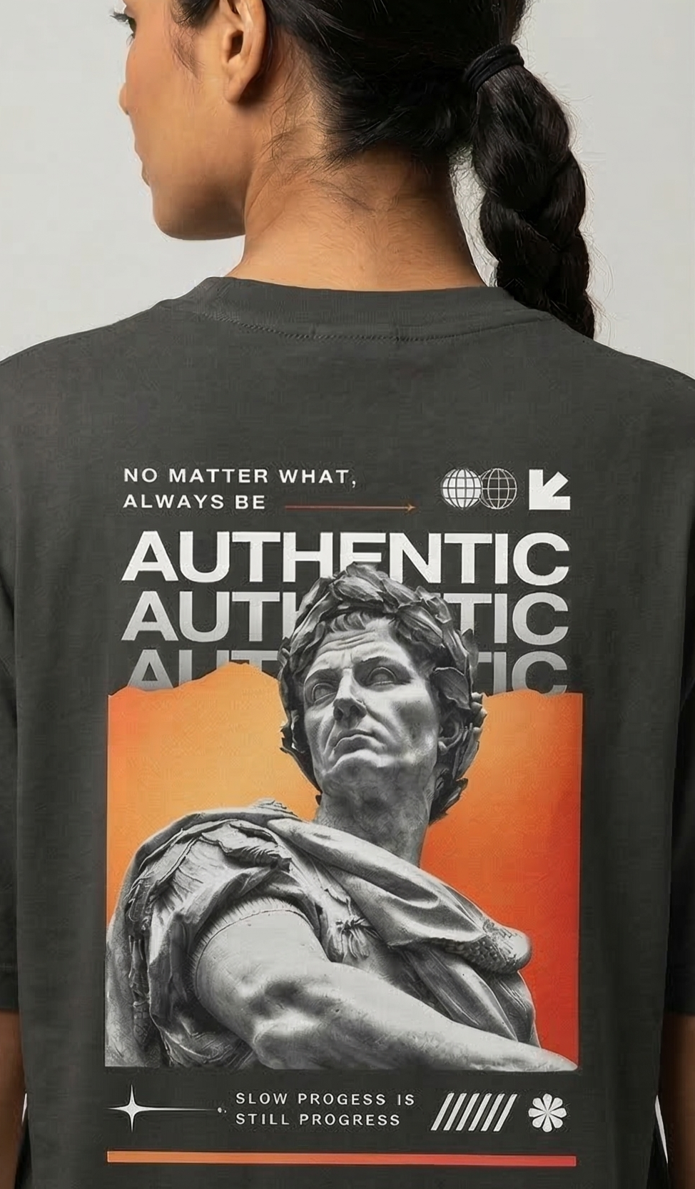 Person wearing a t-shirt with a statue graphic and motivational text on the back.