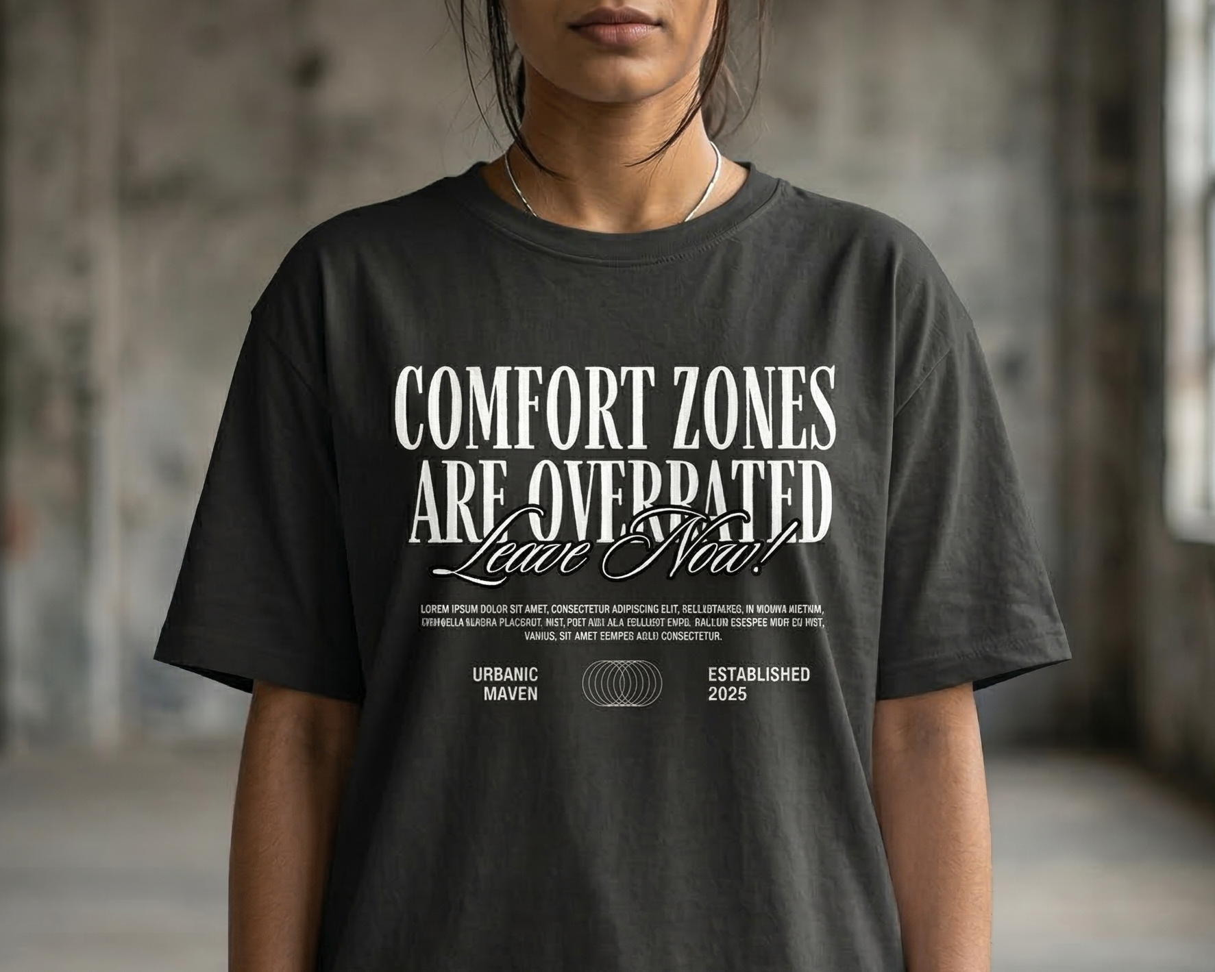 Closeup of a girl wearing a black t-shirt with motivational text in an industrial setting