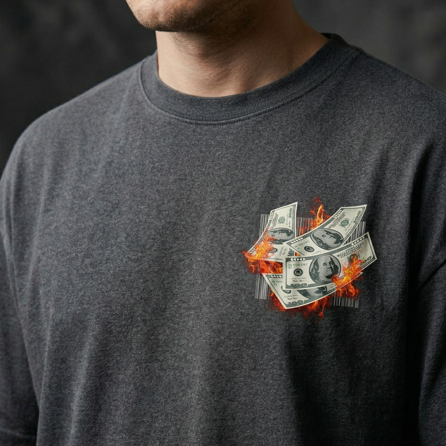 Person wearing a dark black t-shirt with a graphic of money on fire.
